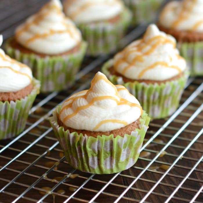 Caramel Macchiato Cupcakes - Delicious coffee sponge with a hidden caramel centre, topped with whipped vanilla cream and drizzled with a bit more caramel.