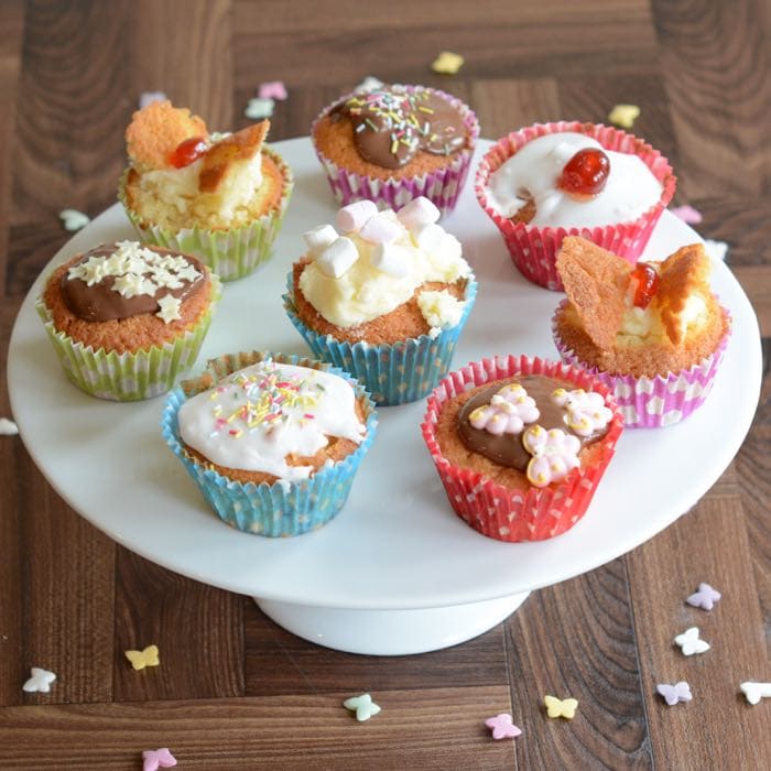 Two pastel fairy cakes, one lemon, one lilac set on white background Stock  Photo - Alamy