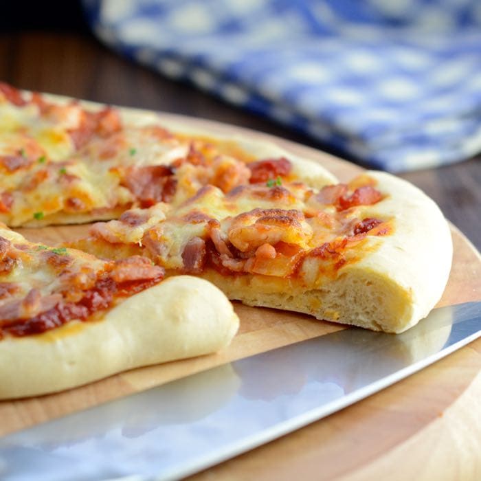 My new favourite pizza recipe - soft, yet crispy pizza dough topped with tomato sauce with a hint of barbecue flavour, chicken, smoked bacon and melted cheese.