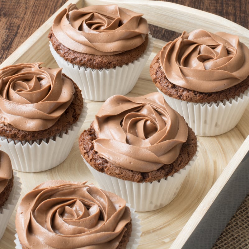 A tray with six Nutella cupcakes topped with Nutella buttercream.
