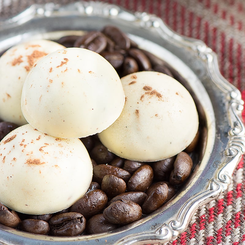 Cappuccino truffles - A soft milk chocolate and coffee ganache centre, coated in white chocolate and sprinkled with a little cocoa powder.