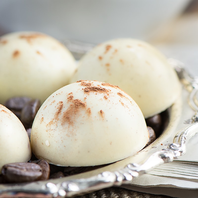 Cappuccino truffles - A soft milk chocolate and coffee ganache centre, coated in white chocolate and sprinkled with a little cocoa powder.