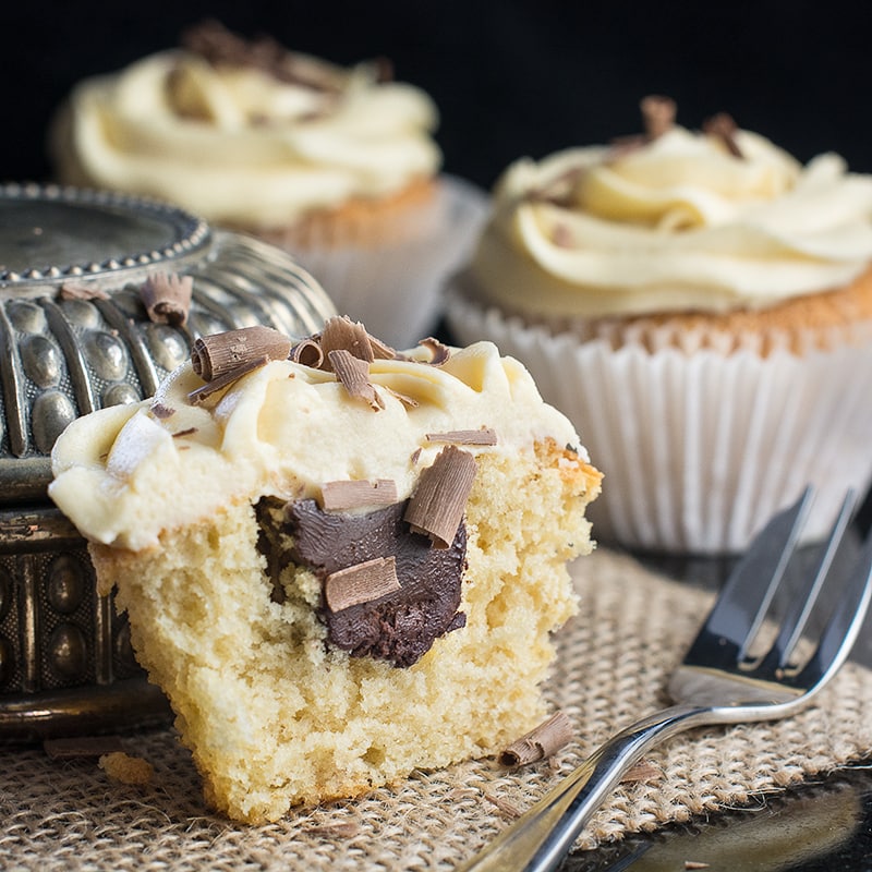 White Russian Cupcakes inspired by the classic cocktail - Baileys whipped cream sponge, topped with a White Russian buttercream and a hidden dark chocolate and vodka ganache centre.