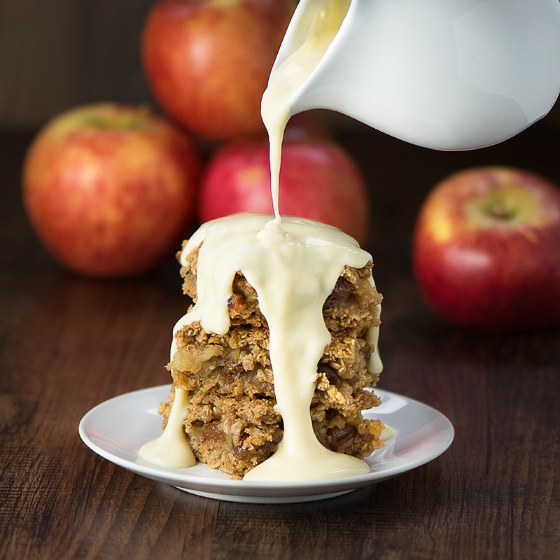 Apple crumble flapjacks - Golden flapjacks with a layer of juicy apple and raisins. Perfect on their own as a snack or smothered in hot homemade custard for a warming dessert.