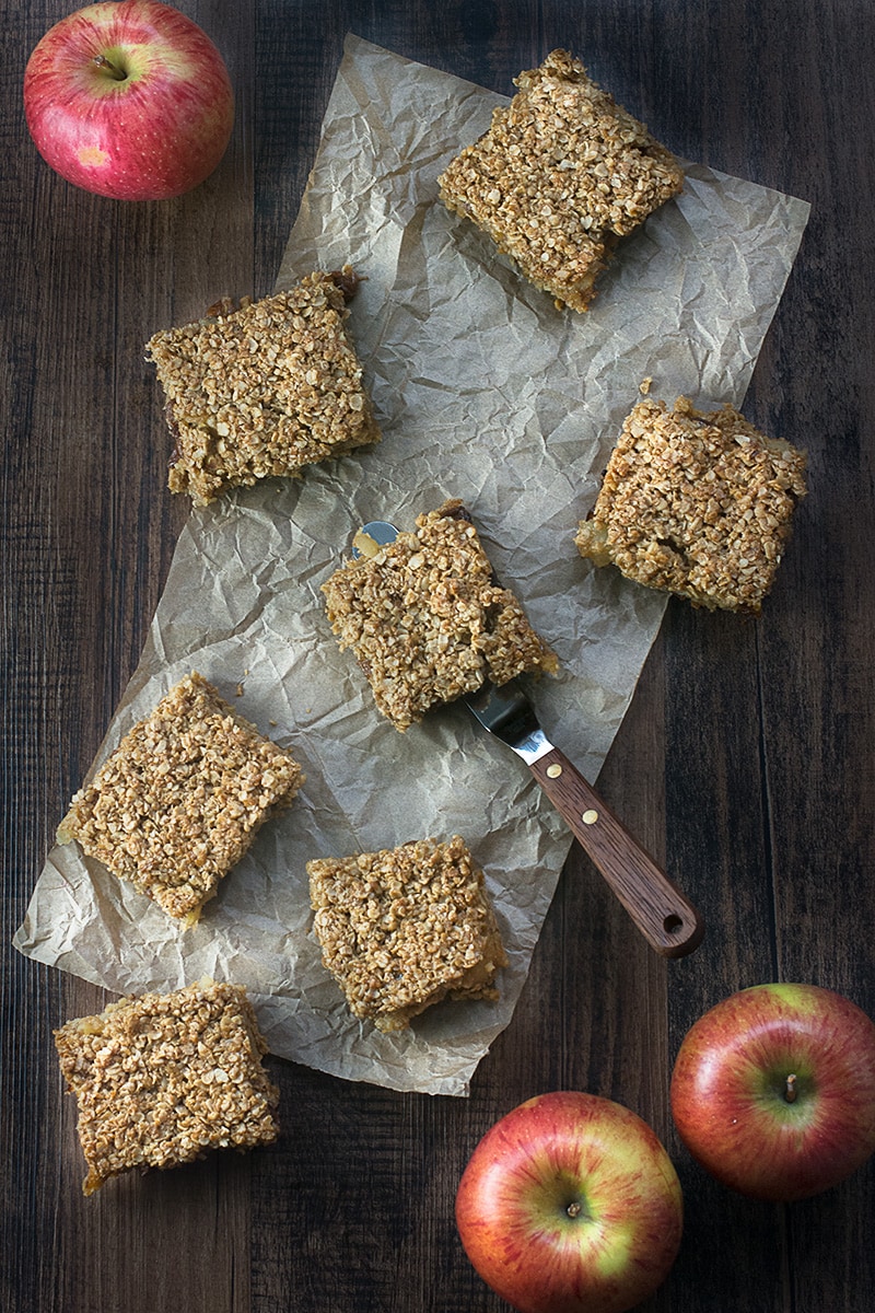 Apple crumble flapjacks - Golden flapjacks with a layer of juicy apple and raisins. Perfect on their own as a snack or smothered in hot homemade custard for a warming dessert.