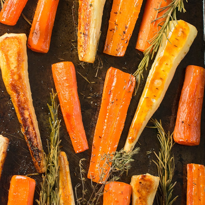 Honey roasted carrots and parsnips with rosemary and thyme - easy to prepare and delicious to eat. The perfect accompaniment to your roast dinner.