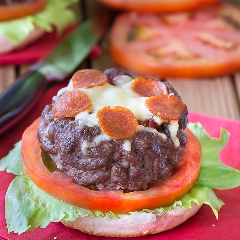 Take your homemade burgers to the next level with these juicy beef burgers topped with tomato sauce, cheese and slices of pepperoni.