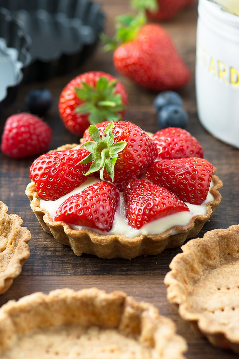 Summer berry and custard tarts - crispy pastry filled with creamy vanilla custard and topped with fresh, juicy berries. A delicious, elegant summer dessert.