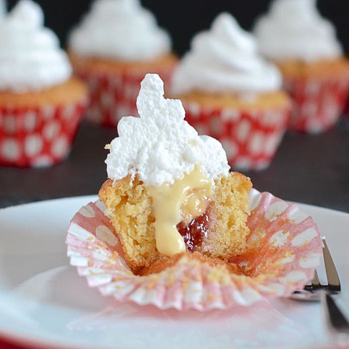 Queen of puddings cupcakes - Vanilla sponge with a hidden raspberry jam and custard centre and topped with an italian meringue frosting.