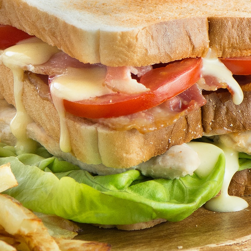 How to make the ultimate club sandwich - A double decker toasted sandwich with crispy bacon, succulent chicken, lettuce, tomato and delicious homemade mayonnaise.