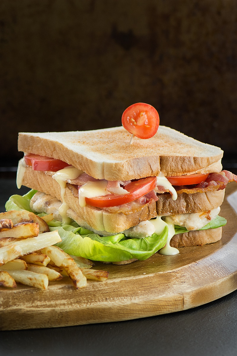How to make the ultimate club sandwich - A double decker toasted sandwich with crispy bacon, succulent chicken, lettuce, tomato and delicious homemade mayonnaise.