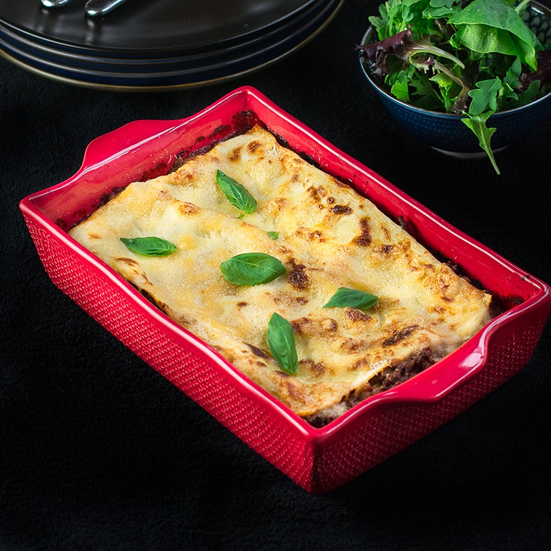 Delicious beef lasagne - layers of pasta filled with a rich beef bolognese, creamy béchamel sauce and plenty of grated cheese.