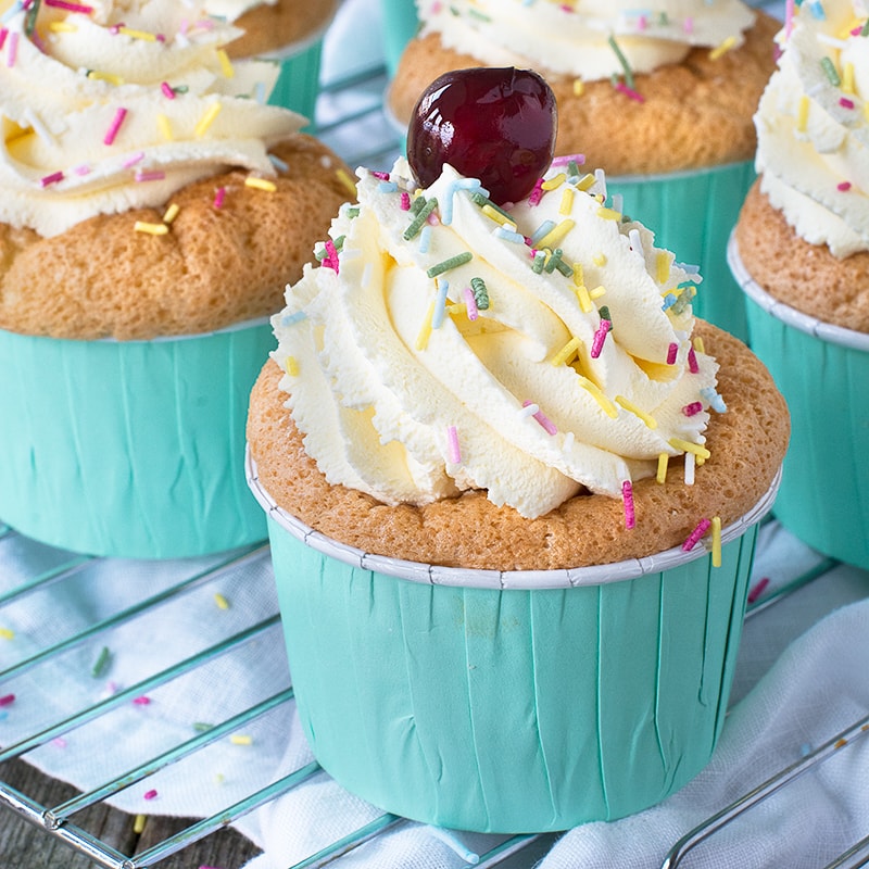 The classic dessert in cupcake form - Raspberry soaked sponge finger-style cupcakes filled with fresh raspberries and custard and topped with whipped vanilla cream.