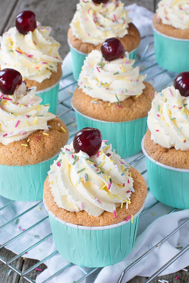 The classic dessert in cupcake form - Raspberry soaked sponge finger-style cupcakes filled with fresh raspberries and custard and topped with whipped vanilla cream.