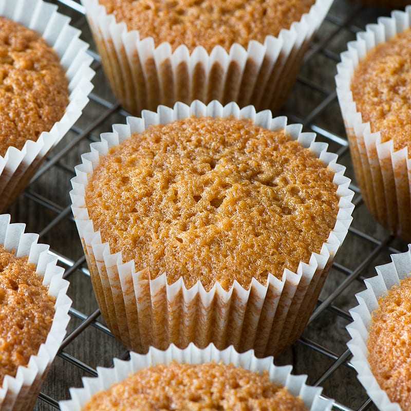 Caramel cupcakes on a cooling rack.