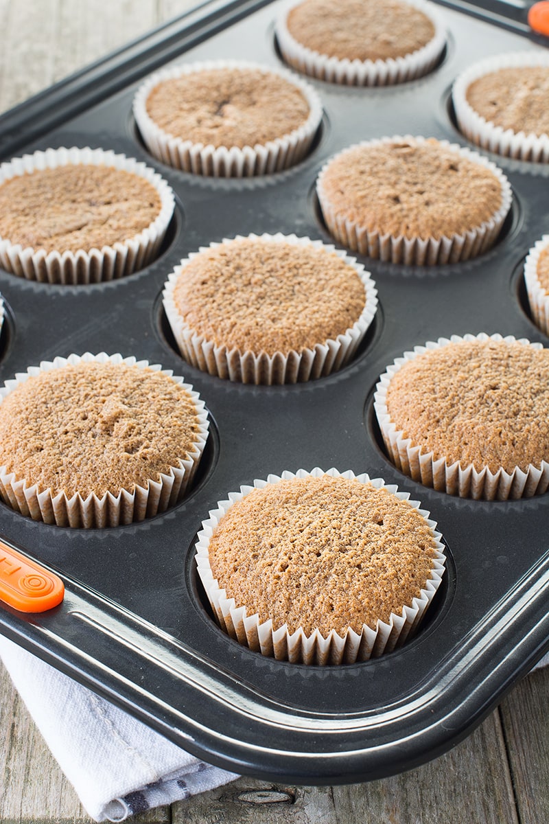 Freshly baked coffee cupcakes in a muffin tin.