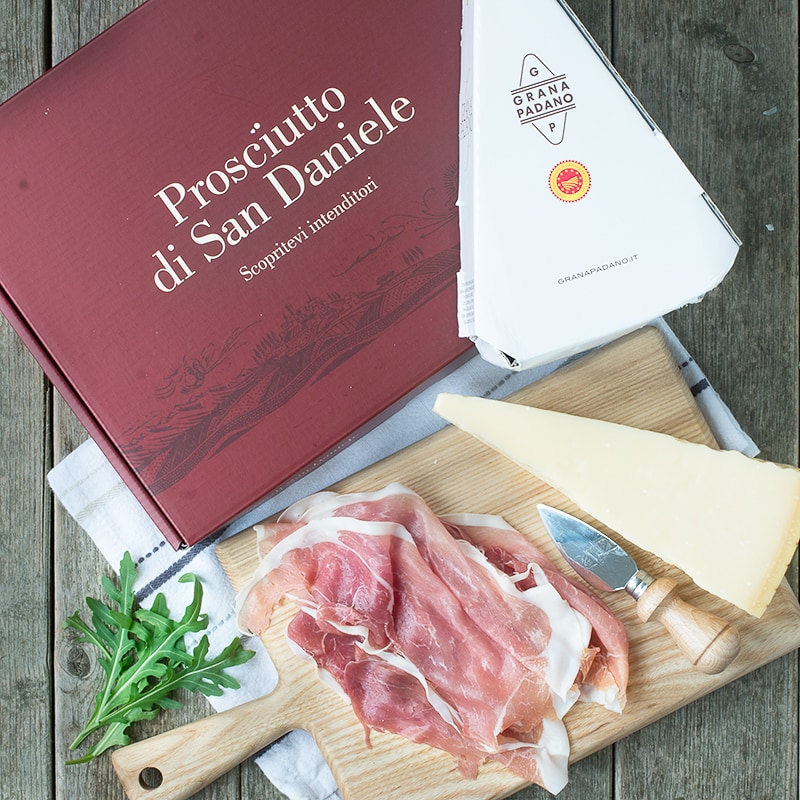 Prosciutto di San Daniele and Grana Padano cheese with their packaging.
