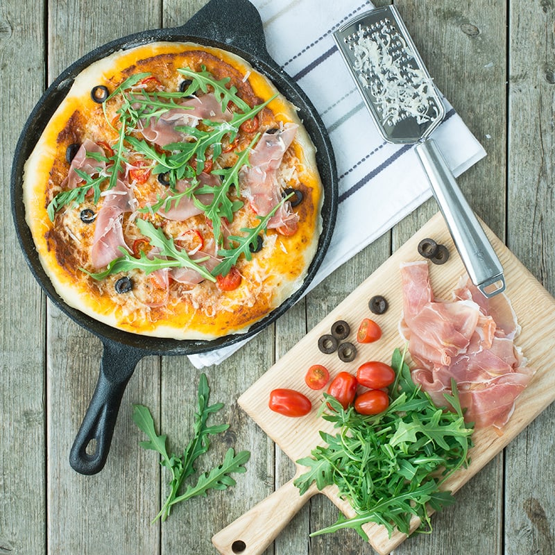 A delicious homemade pizza topped with sun dried tomato pesto, olives, chillies and Grana Padano cheese and then finished with Prosciutto di San Daniele and rocket.