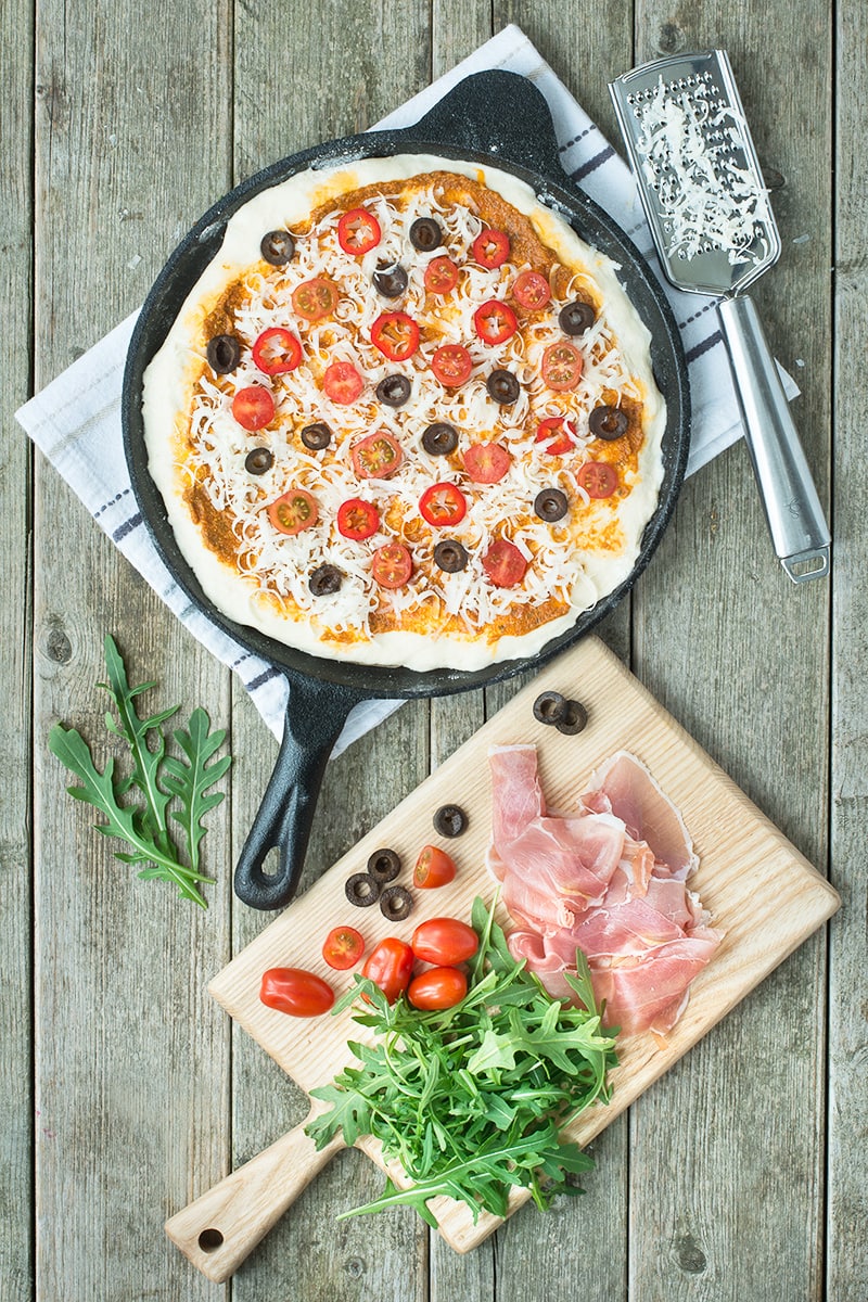 A delicious homemade pizza topped with sun dried tomato pesto, olives, chillies and Grana Padano cheese and then finished with Prosciutto di San Daniele and rocket.