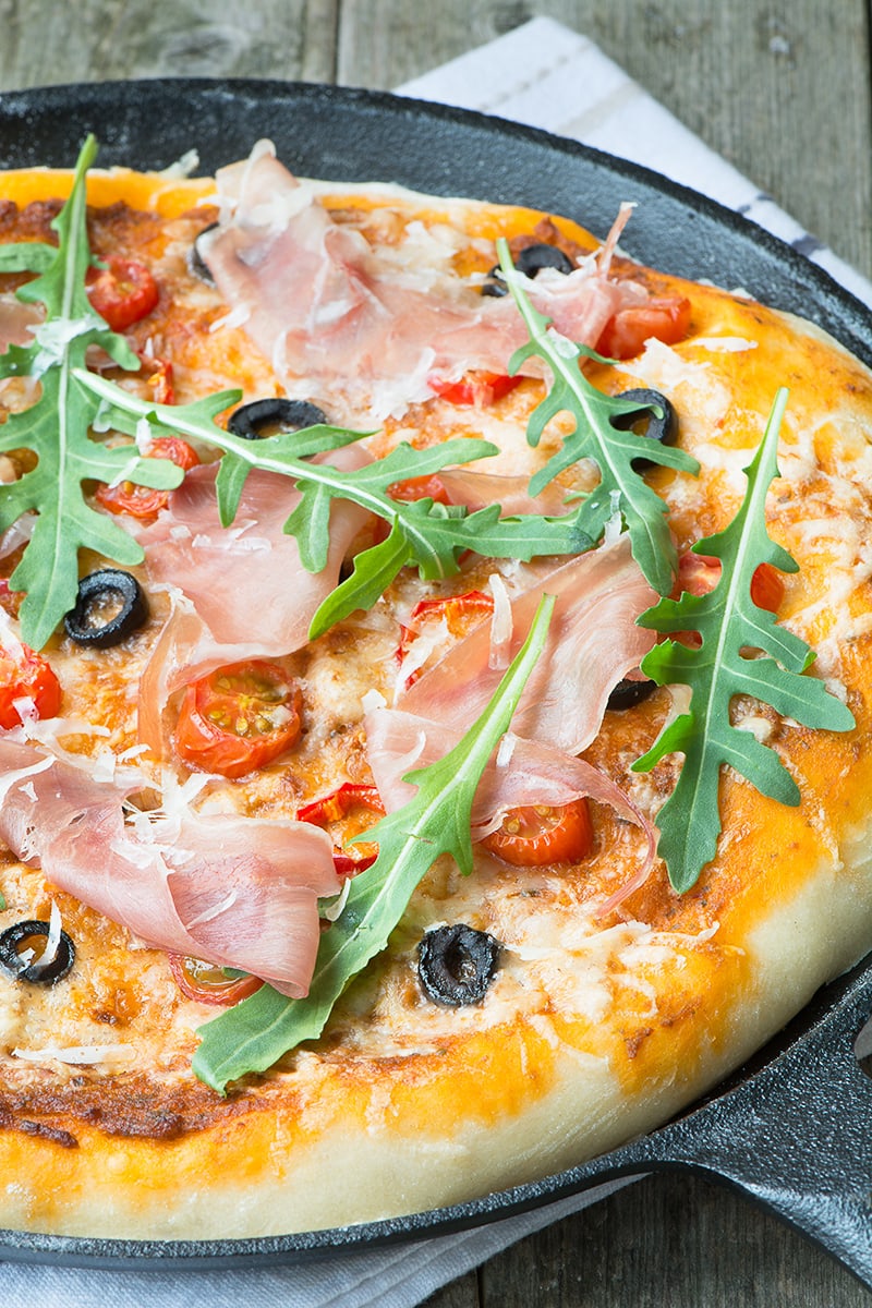 A delicious homemade pizza topped with sun dried tomato pesto, olives, chillies and Grana Padano cheese and then finished with Prosciutto di San Daniele and rocket.