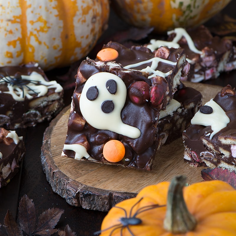 Spooky Rocky Road - a delicious and easy to make Halloween treat packed with crunchy biscuits, Smarties, marshmallows and lots of chocolate. There's an option to make it taste like Chocolate Orange too!