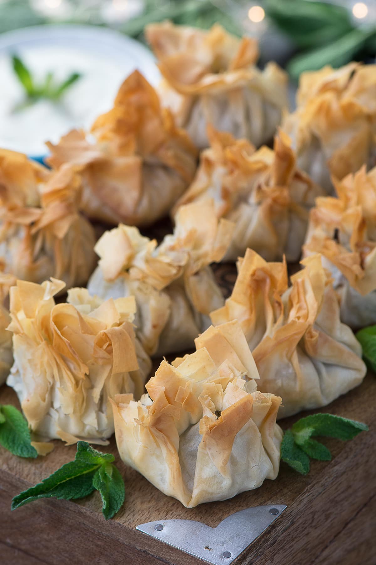 Crisp filo pastry parcels with a spiced lamb, feta and spinach filling served with a mint yogurt dip. 
