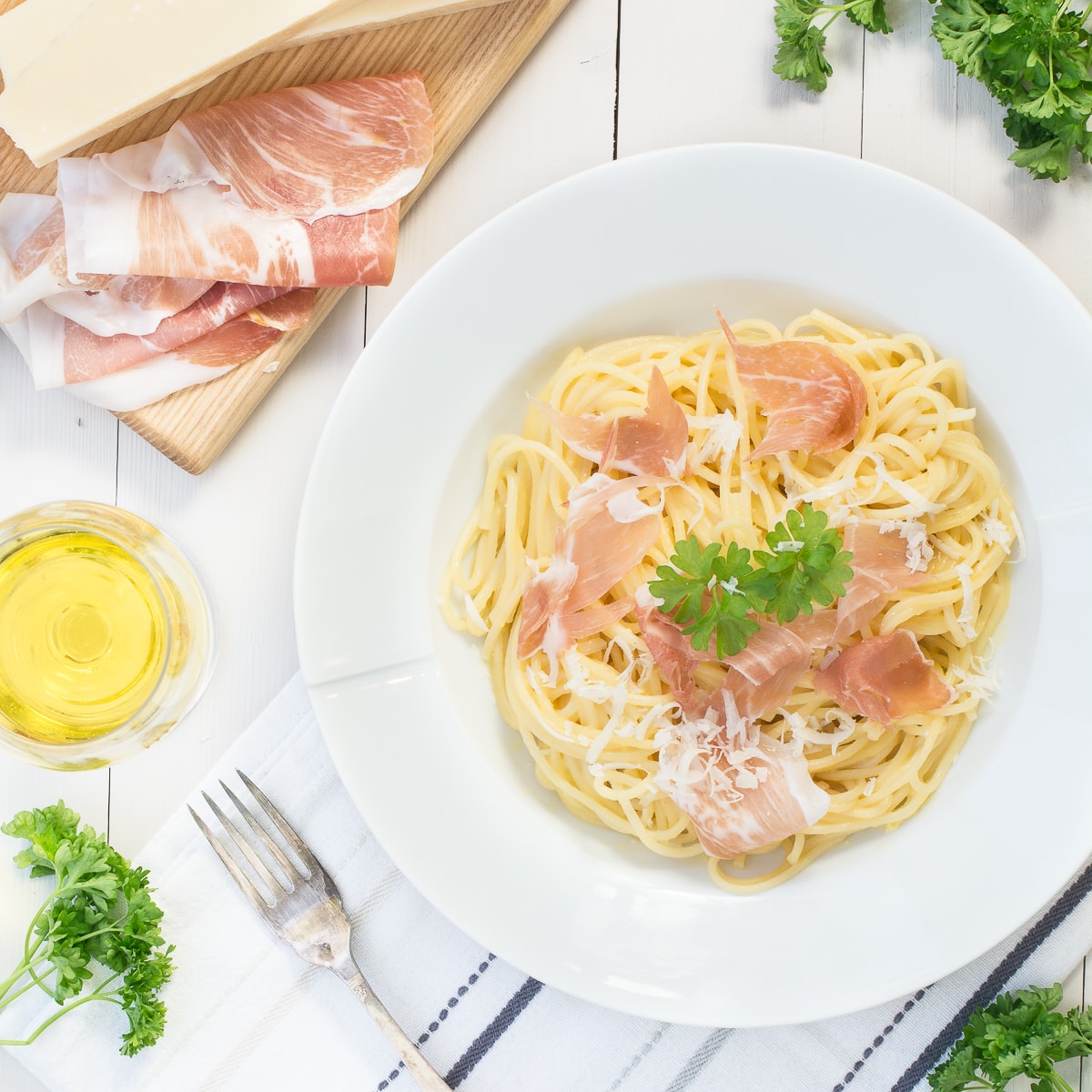 Looking down at a delicious bowl of creamy spaghetti carbonara made with Prosciutto di San Daniele and Grana Padano cheese.