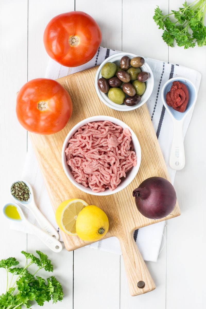 Ingredients for Mediterranean Lamb Stuffed Tomatoes - Tomatoes, mixed olives, lamb mince, red onion, lemon, tomato puree, olive oil, herbs and spices