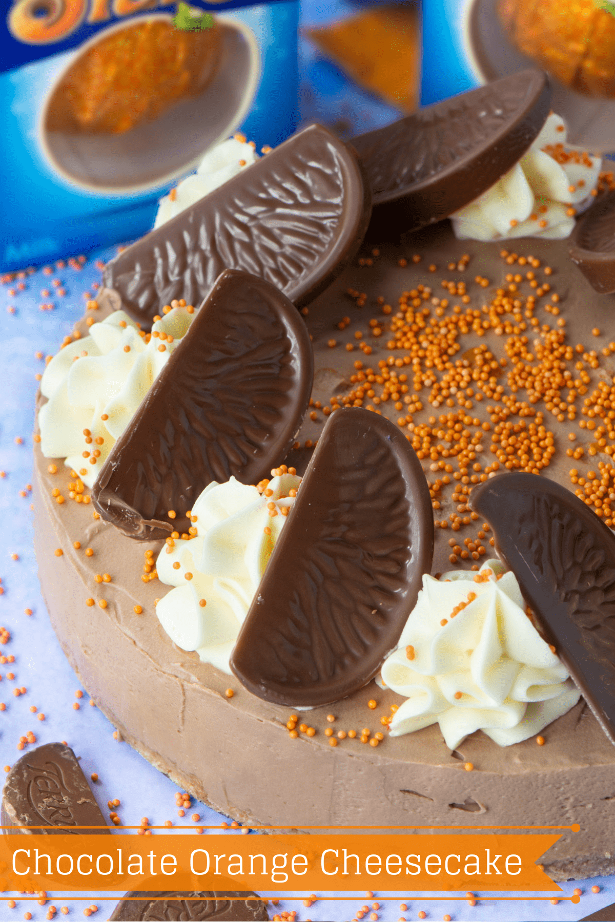 Chocolate Orange Cheesecake - A delicious and easy to make no-bake dessert. A smooth chocolate orange flavoured cheesecake topped with swirls of white chocolate orange cheesecake and slices of Chocolate Orange. A dessert lover's dream.