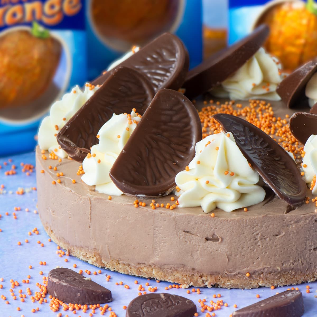 Chocolate Orange Cheesecake - A delicious and easy to make no-bake dessert. A smooth chocolate orange flavoured cheesecake topped with swirls of white chocolate orange cheesecake and slices of Chocolate Orange. A dessert lover's dream.