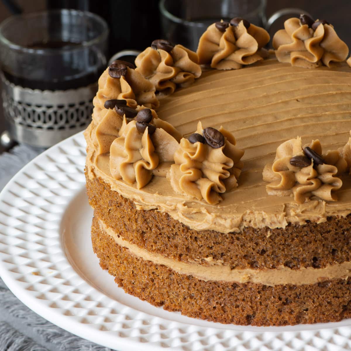 Easy Coffee Cake - A delicious all-in-one coffee sponge topped with smooth coffee buttercream. Simple to make and packed full of flavour. PLUS - How to make this cake in any size of round, square or rectangular tin. 