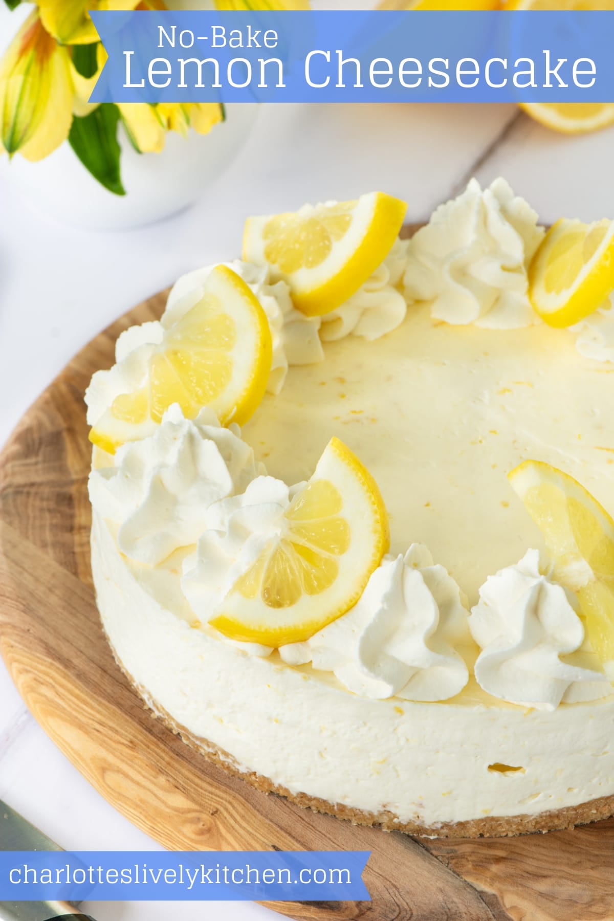 Lemon cheesecake topped with whipped cream and lemon slices.