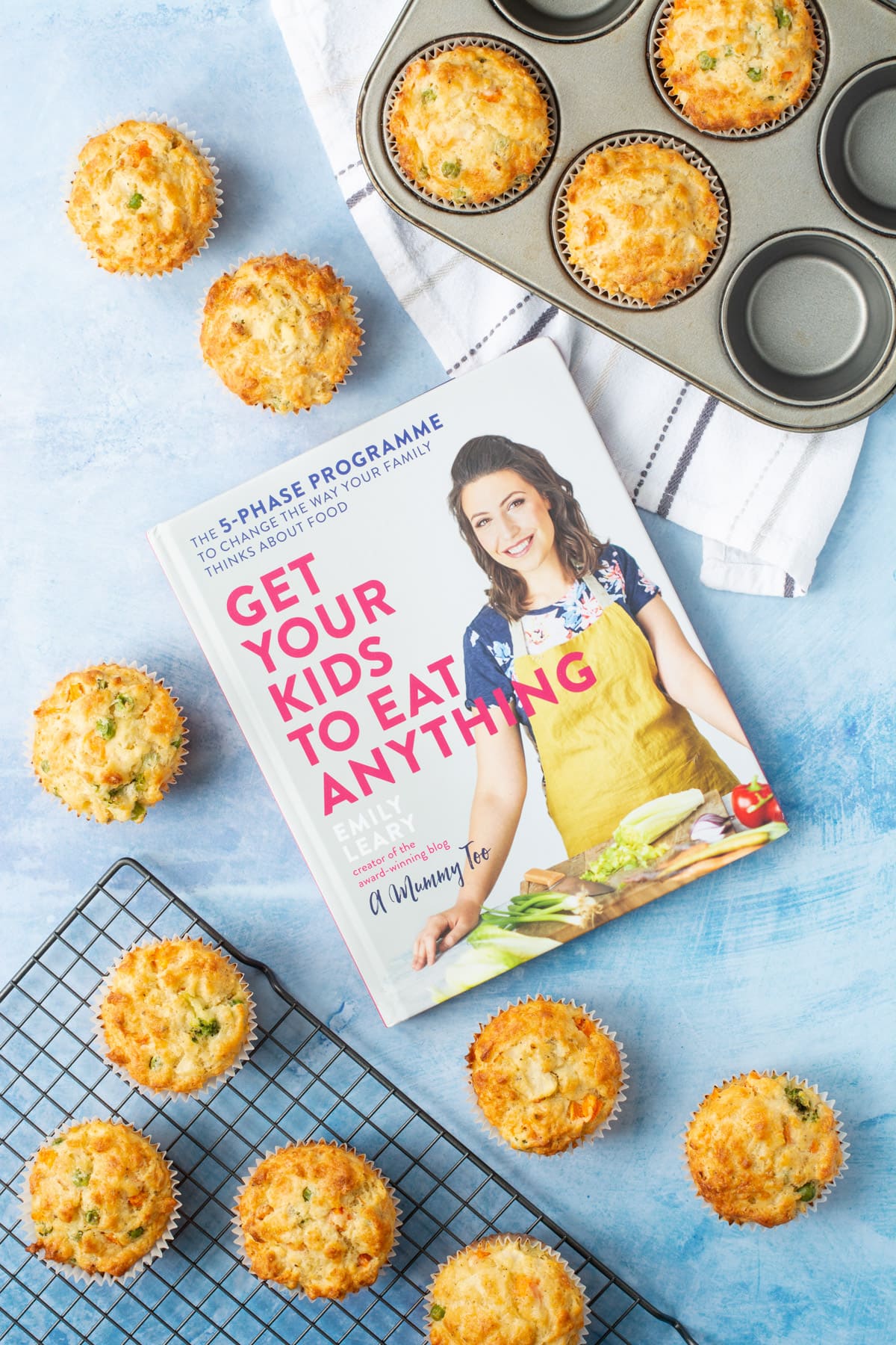 Get Your Kids To Eat Anything cookbook surrounded by savoury muffins.