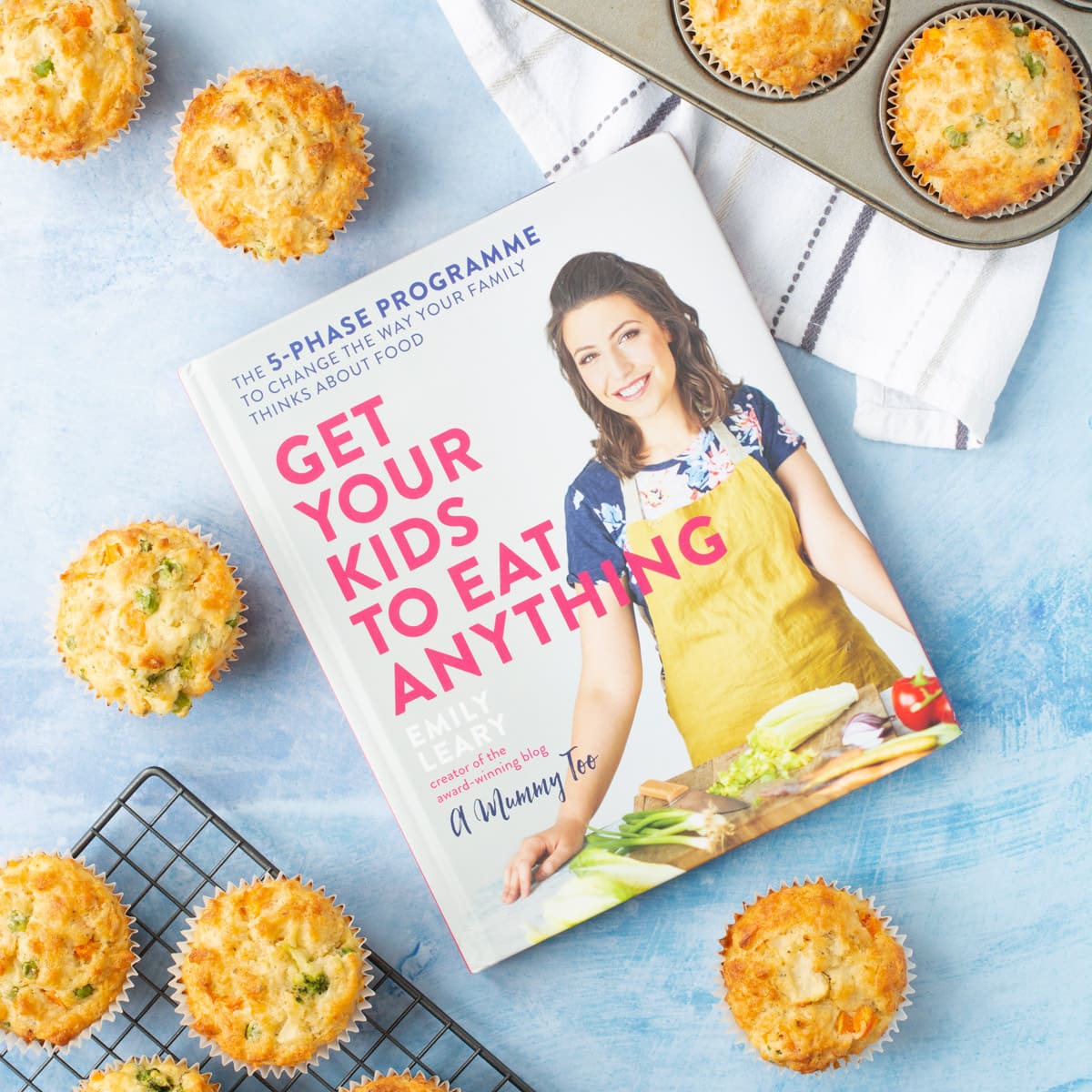 Get Your Kids To Eat Anything cookbook surrounded by savoury muffins.