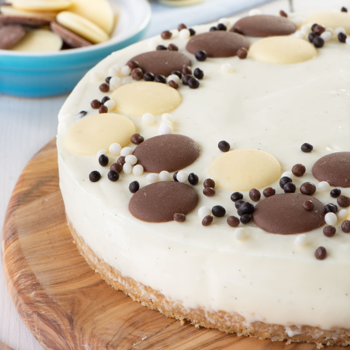 A white chocolate cheesecake on a wooden board.