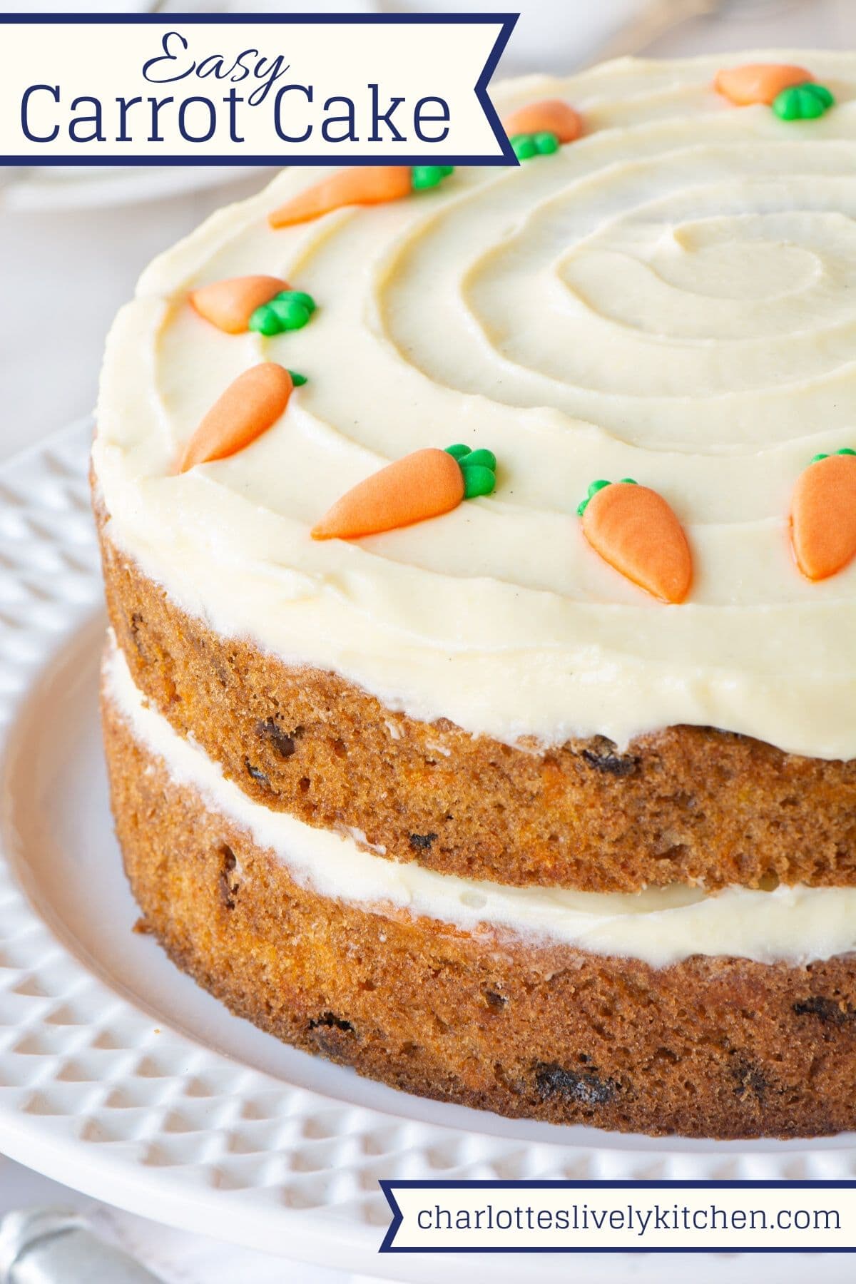 A two-later carrot cake with cream cheese buttercream, decorated with sugar carrots. The image has the text Easy Carrot Cake at the top.