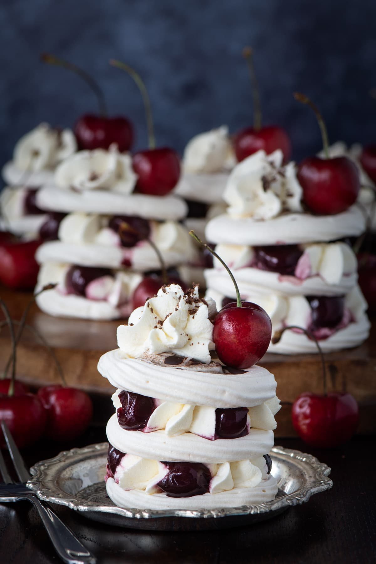 A Black Forest Meringue Stack. Three layers of meringue sandwiched with piped whipped cream and cherries.