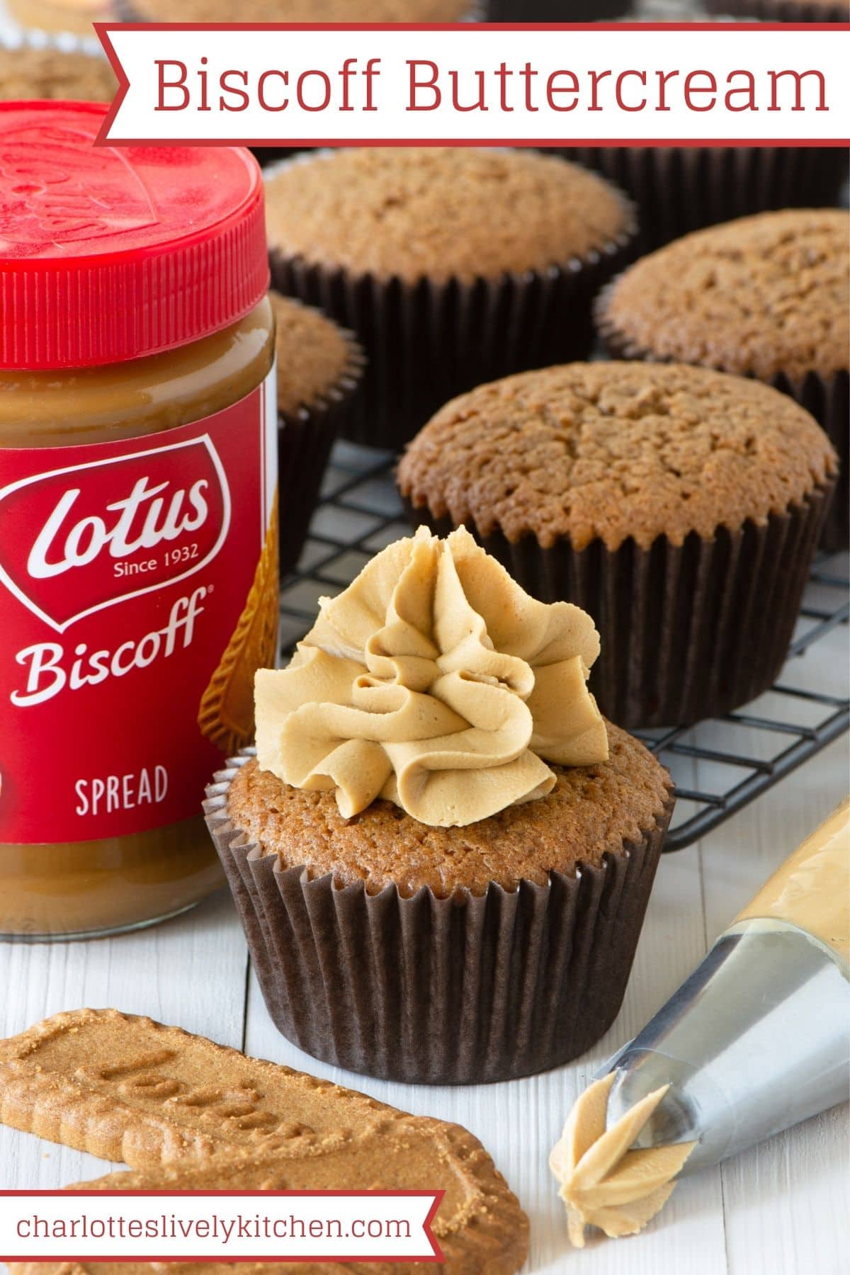 A cupcake topped with Biscoff buttercream next to a jar of Lotus Biscoff spread and a piping bag filled with buttercream.