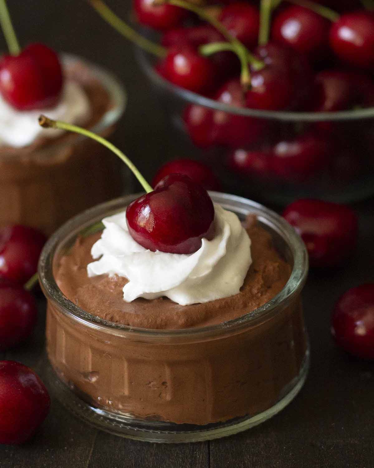 Chocolate mousse topped with a cherry.