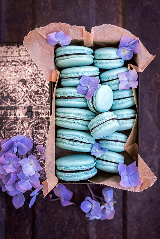 Blue macarons filled with ganache.