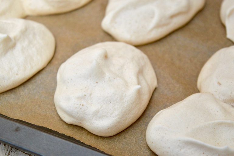 Brown sugar meringues on parchment paper.