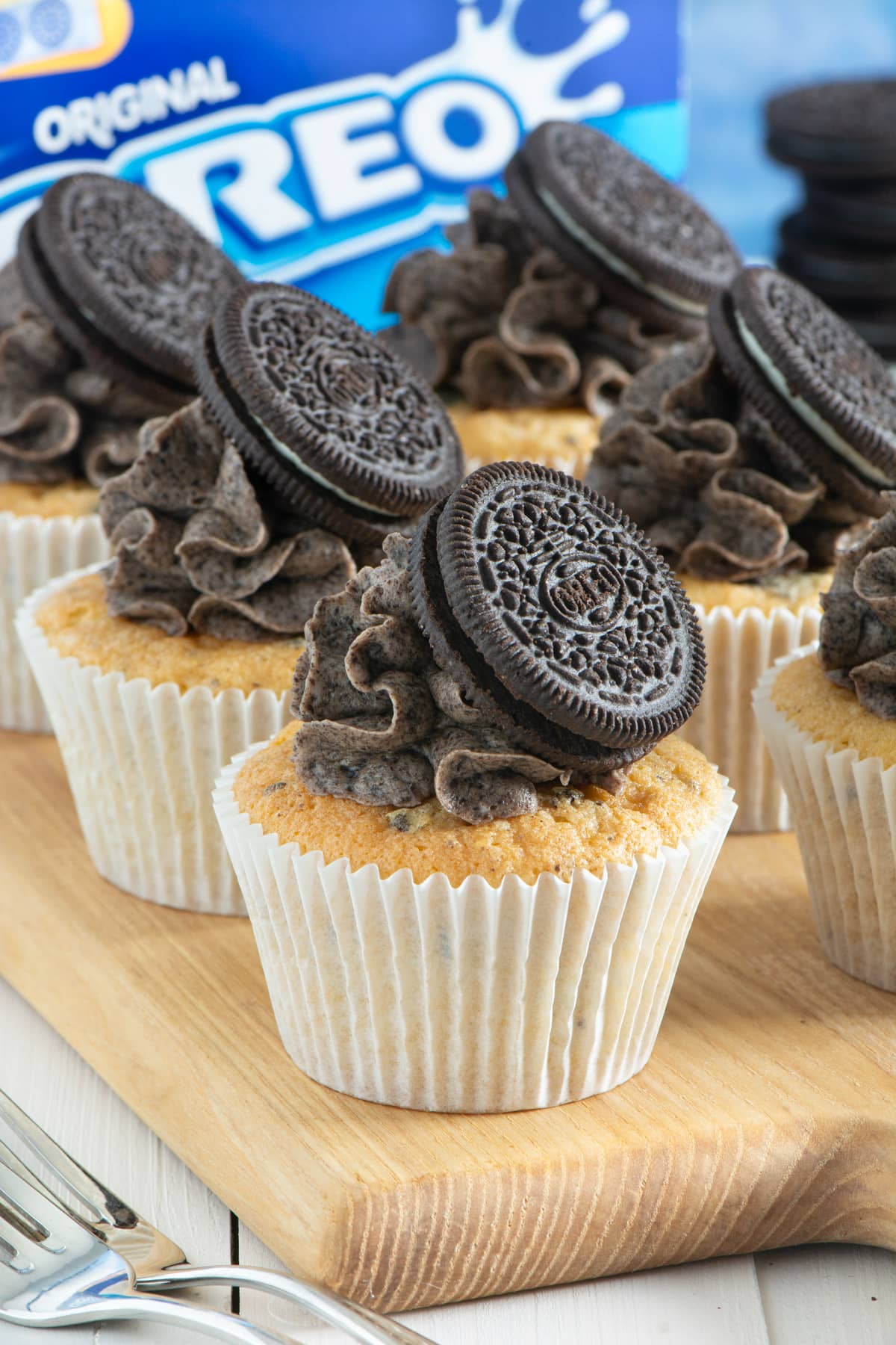 Decorated oreo cupcakes on a wooden board. 