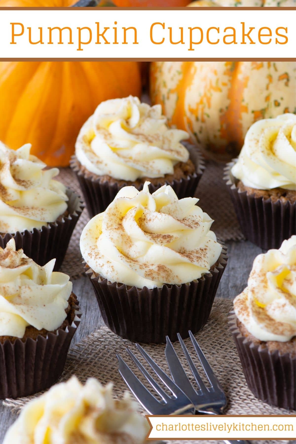 Pinterest graphic image showing frosted pumpkin cupcakes in front of 2 orange pumpkins and with 2 serving forks to the front with the website name shown at the bottom and recipe title shown at the top. 