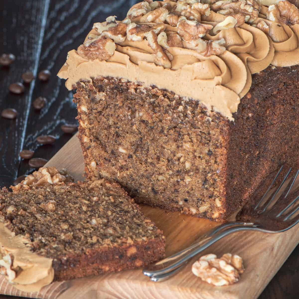 Coffee and walnut loaf cake which has been sliced.