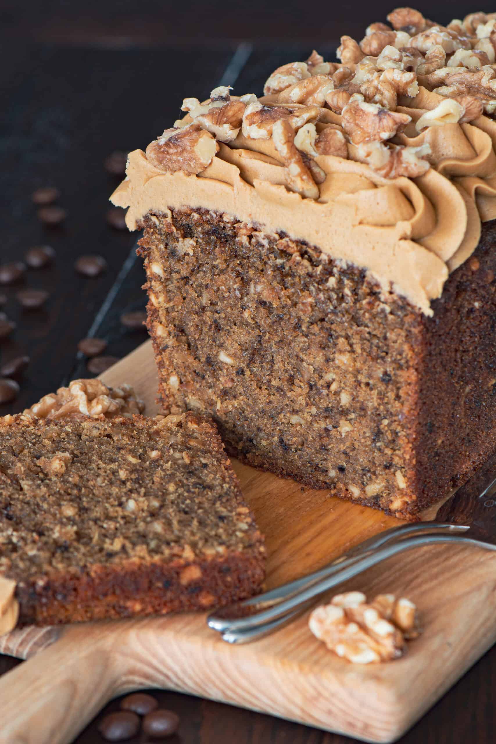 Coffee and walnut loaf cake which has been sliced.