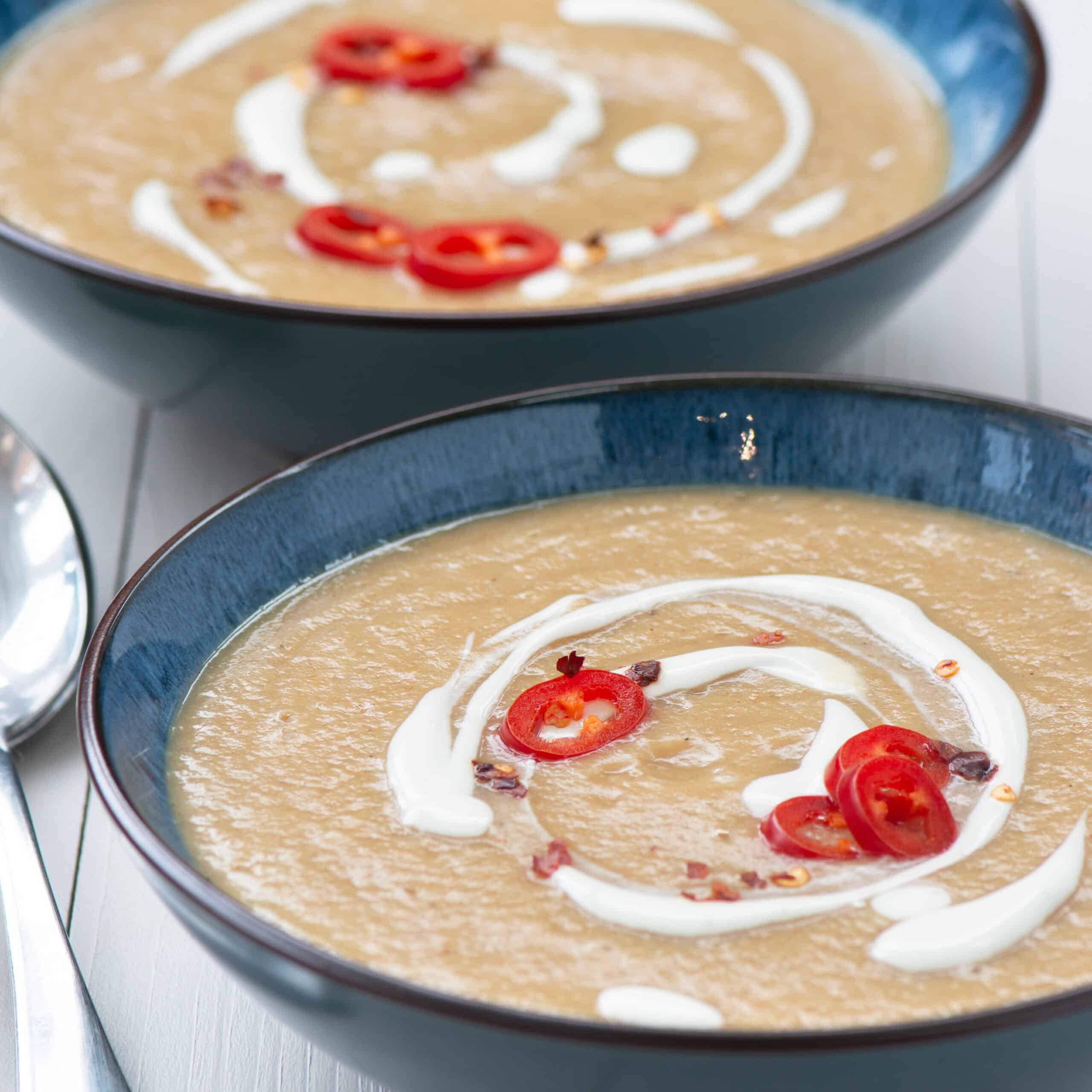 Two bowls of spiced parsnip soup