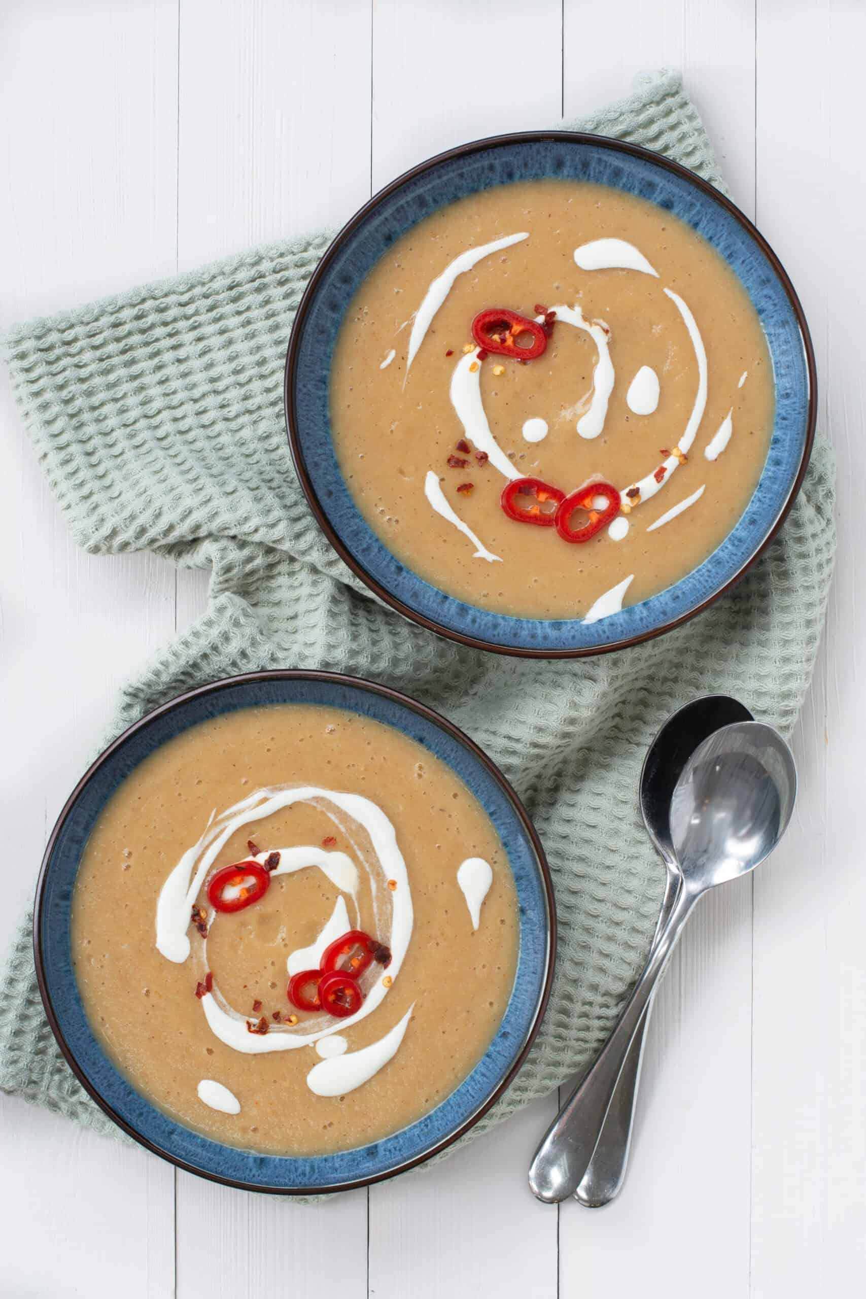 Two bowls of spiced parsnips soup from above.